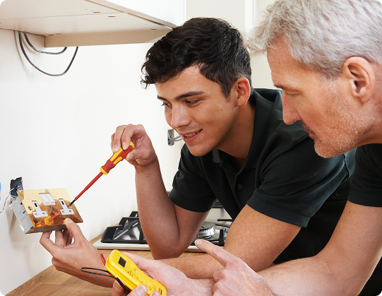 electricians working on an outlet